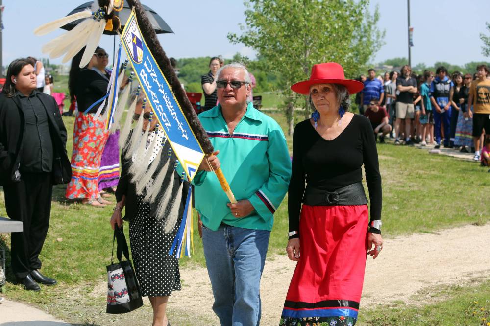 Frank Tacan and BU chancellor Mary Jane McCallum lead the grand entry for the Our Journey, Indigenous Student Graduation Celebration at the Riverbank Discovery Centre in Brandon on Wednesday.