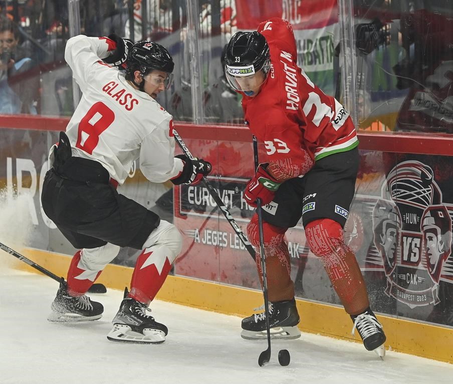 Cody Glass, left, of Canada challenges Milan Horvath of Hungary for the puck during the friendly ice hockey match between Hungary and Canada in Budapest, Hungary, Tuesday, May 9, 2023. (Tibor Illyes/MTI via AP)