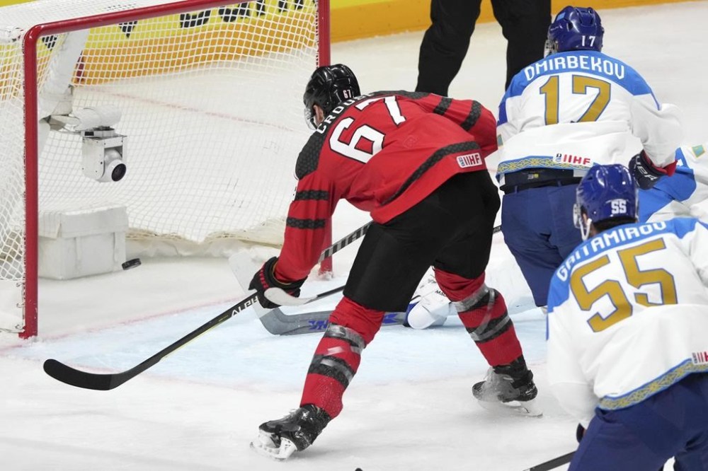 Lawson Crouse of Canada, center, scores past the goalie Nikita Boyarkin of Kazakhstan, during the group B match between Canada and Kazakhstan at the ice hockey world championship in Riga, Latvia, Wednesday, May 17, 2023. Crouse scored twice as Canada remained unbeaten at the world hockey championship with a 5-1 win over Kazakhstan on Wednesday. THE CANADIAN PRESS/AP-Roman Koksarov