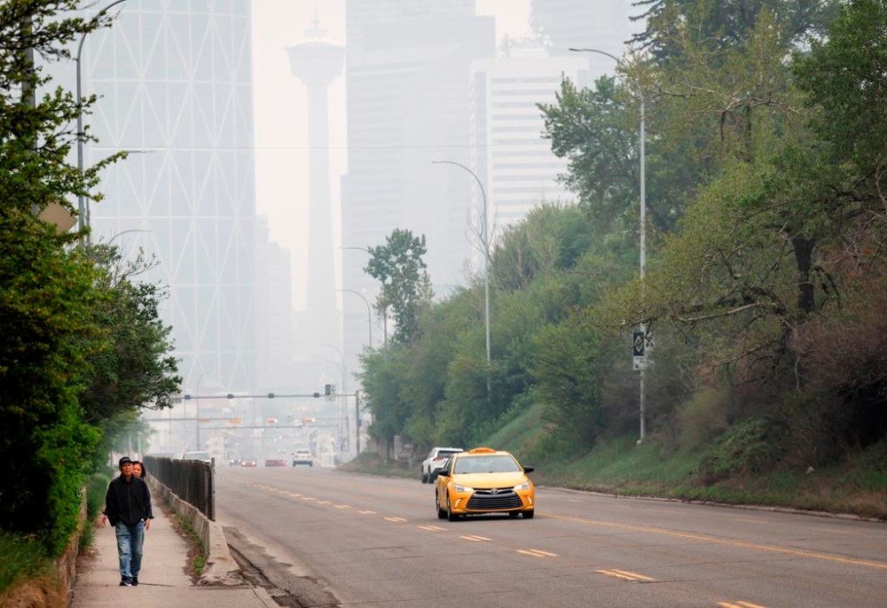 Thick smoke from wildfires blankets the downtown for a second day in Calgary, Alta., Wednesday, May 17, 2023. Smoke in the air threw a wrench into the start of Calgary Stampeders' training camp, but there were still jobs to be earned and important pre-season reps to accomplish. THE CANADIAN PRESS/Jeff McIntosh