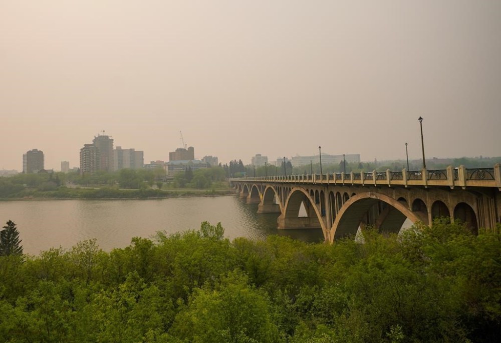 University Bridge is photographed through thick smoke from wildfires burning across the Prairies, in Saskatoon on Saturday, May 20, 2023. THE CANADIAN PRESS/Heywood Yu