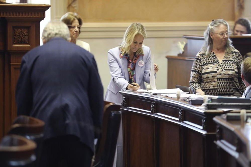 South Carolina Sen. Sandy Senn, R-Charleston, signs paperwork before the Senate begins debating a stricter law on abortion on Tuesday, May, 23, 2023, in Columbia, South Carolina. (AP Photo/Jeffrey Collins)