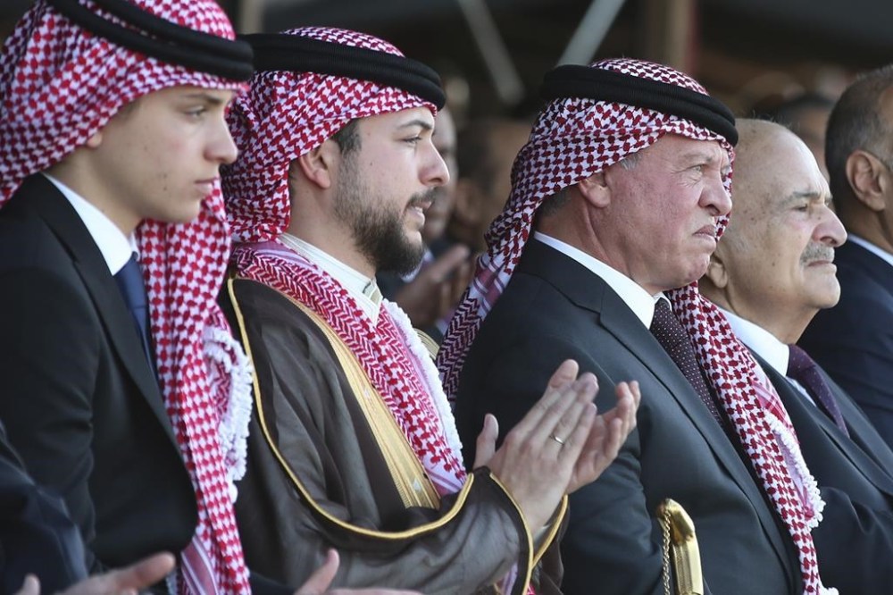 Jordan's Crown Prince Hussein, second left, sits with his father, King Abdullah II, third left, during a celebration in Amman, Jordan, Wednesday, May 31, 2023, a day before his wedding to Saudi architect Rajwa Alseif. (AP Photo/Raad Adayleh)
