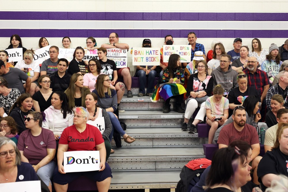At Tuesday evening's school board meeting, Brandon residents hold