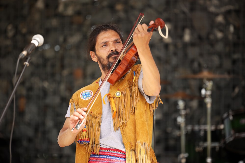 Steven Demontigny with Métis Tradition plays the fiddle while the band performs during National Indigenous Peoples Day celebrations at the Riverbank Discovery Centre in Brandon. (Tim Smith/Brandon Sun)