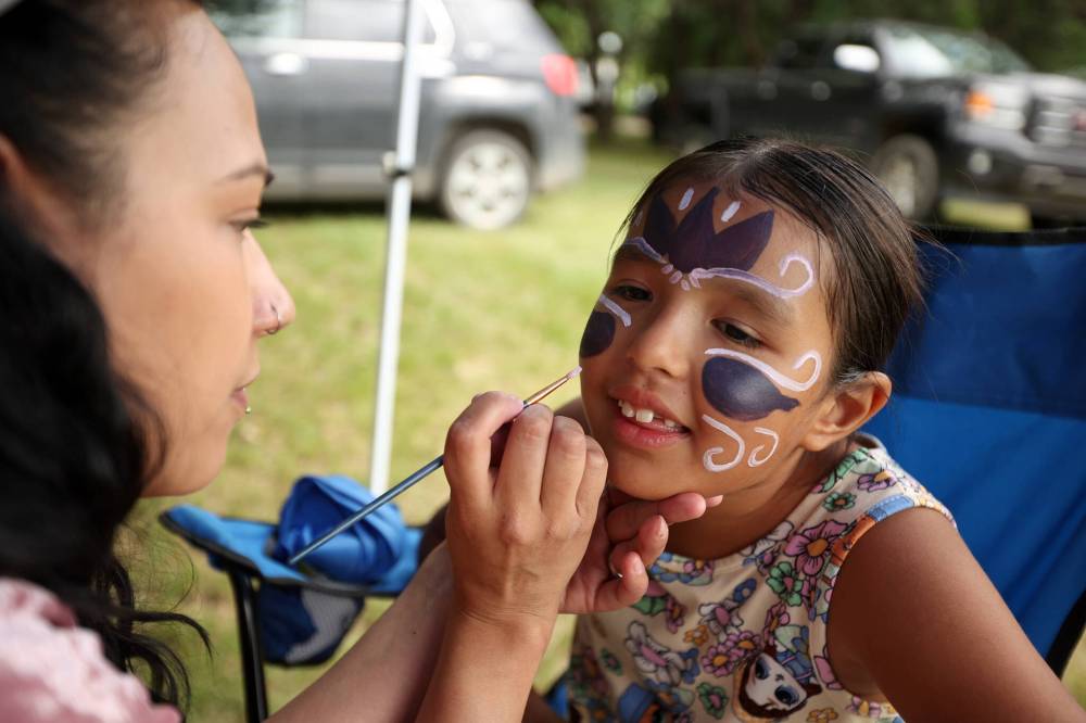 Alexis Waters, 7, has her face painted by Kayla Pratt during Sioux Valley Dakota Nation’s grand reopening of the Grand Valley Campground, which coincided with National Indigenous Peoples Day celebrations on Wednesday. (Tim Smith/The Brandon Sun)