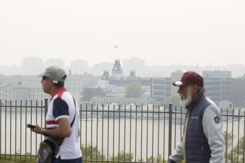 Smoke from wildfires burning across both Ontario and Quebec blanket the skyline in Kingston, Ont., Tuesday, June 6, 2023. Environment Canada has been advising people to check the Air Quality Health Index in recent days. THE CANADIAN PRESS/Lars Hagberg