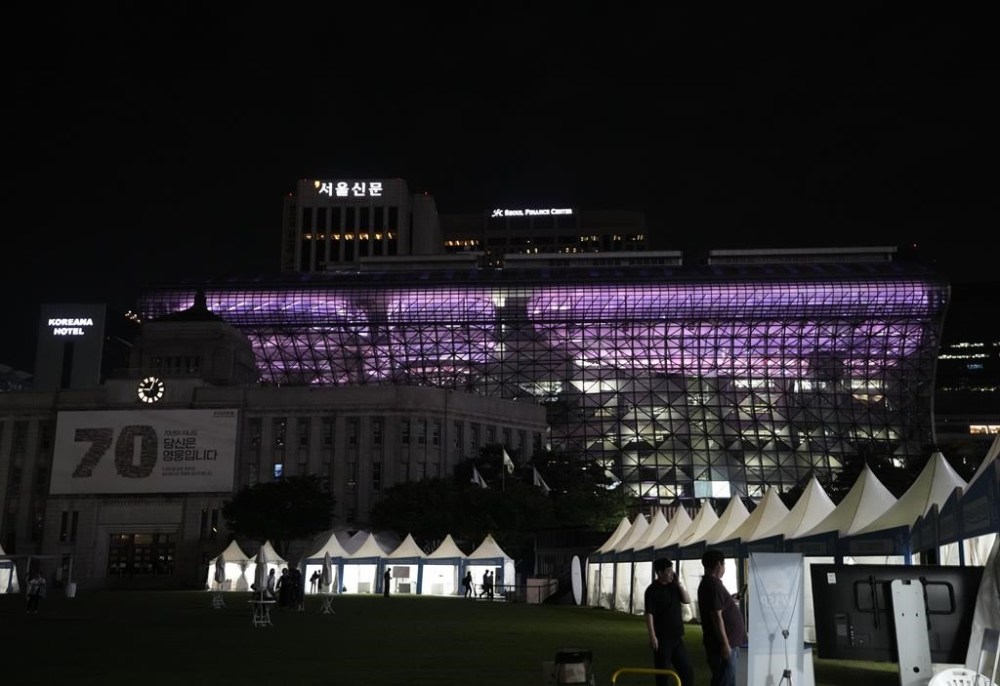 The landmark Seoul City Hall is illuminated in purple in Seoul, South Korea, Monday, June 12, 2023. Skyscrapers, bridges and other landmarks in South Korea's capital will be lit up in purple on Monday as the country begins celebrating the 10th anniversary of K-pop band BTS, whose global popularity is a source of national pride. (AP Photo/Ahn Young-joon)