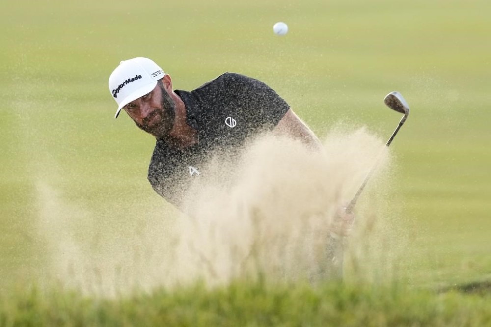 Dustin Johnson hits from the bunker on the 16th hole during the third round of the U.S. Open golf tournament at Los Angeles Country Club on Saturday, June 17, 2023, in Los Angeles. (AP Photo/Marcio J. Sanchez)