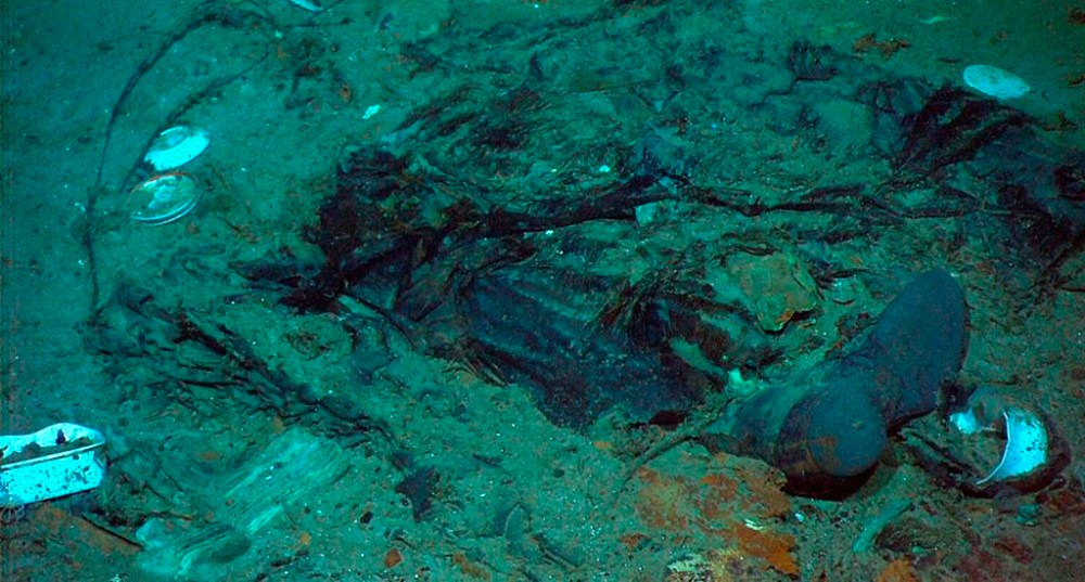 FILE - This 2004 photo provided by the Institute for Exploration, Center for Archaeological Oceanography/University of Rhode Island/NOAA Office of Ocean Exploration, shows the remains of a coat and boots in the mud on the sea bed near the Titanic's stern. Rescuers are racing against time to find the missing submersible carrying five people, who were reported overdue Sunday night, June 18, 2023. (Institute for Exploration, Center for Archaeological Oceanography/University of Rhode Island/NOAA Office of Ocean Exploration, File)
