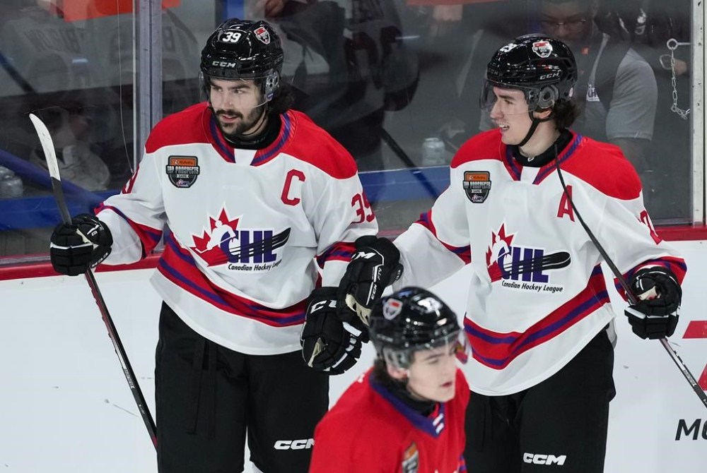 Team White's Colby Barlow (39) and Brayden Yager (29) celebrate Barlow's goal as Team Red's Luca Cagnoni skates past during the first period of the CHL/NHL Top Prospects game, in Langley, B.C., on Wednesday, January 25, 2023. The Winnipeg Jets selected Colby Barlow with the No. 18 pick in the 2023 NHL draft Wednesday. THE CANADIAN PRESS/Darryl Dyck