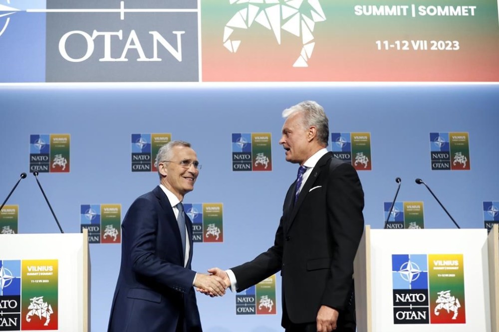 NATO Secretary General Jens Stoltenberg, left, shakes hands with Lithuania's President Gitanas Nauseda after a media conference ahead of a NATO summit in Vilnius, Lithuania, Monday, July 10, 2023. Russia's war on Ukraine will top the agenda when NATO leaders meet in the Lithuanian capital Vilnius on Tuesday and Wednesday. (AP Photo/Mindaugas Kulbis)