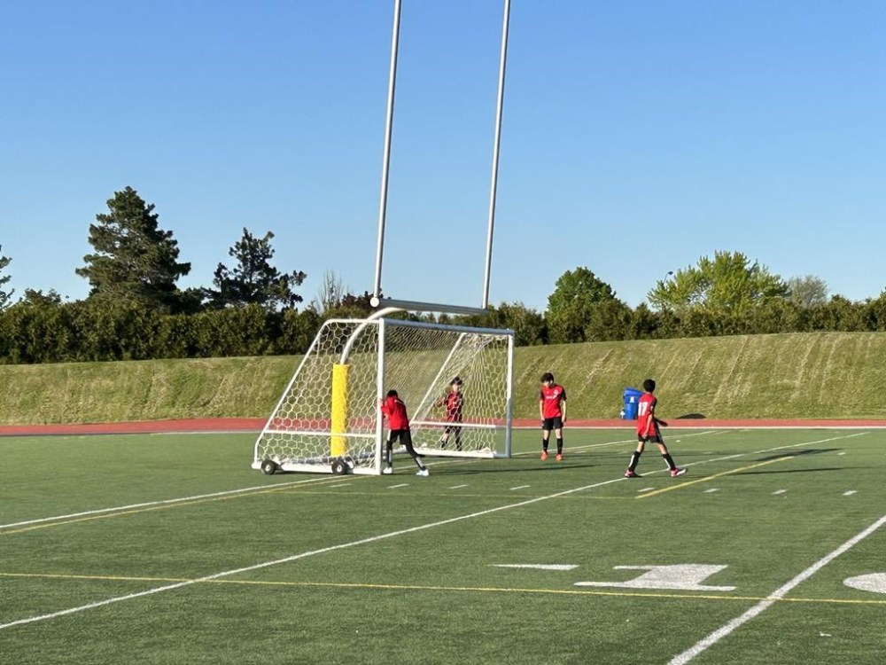 Youth soccer players move a net into position at Centennial Park in Toronto on May 25, 2023. THE CANADIAN PRESS/Liam Casey