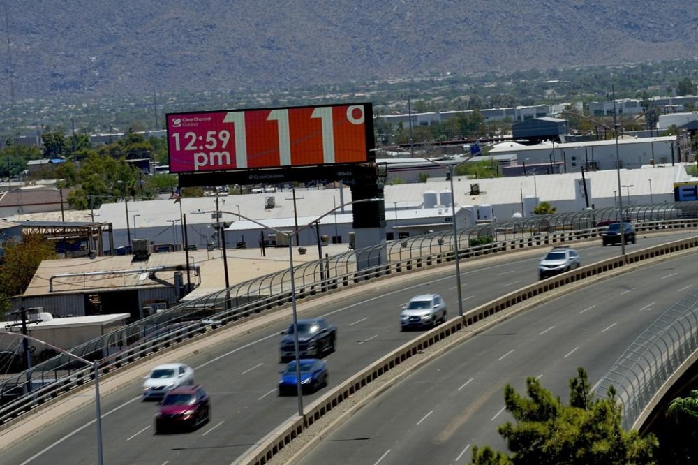 A digital billboard displays the temperature on Monday, July 17, 2023 in downtown Phoenix. (AP Photo/Matt York)