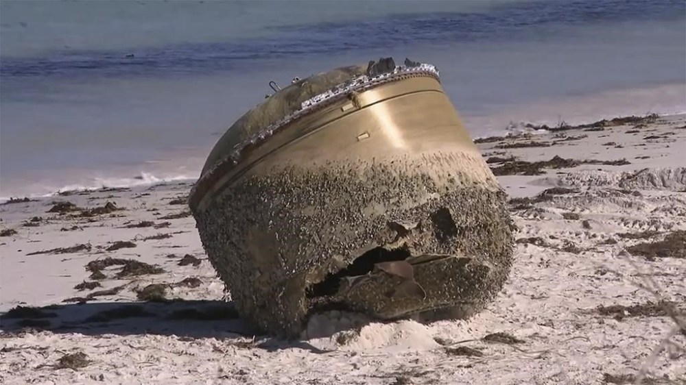 In this image made from video, a cylindrical object is seen on beach in Green Head, Australia, July 17, 2023. Authorities were investigating on Tuesday whether a cylindrical object about the size of a small car that washed up on a remote Australian beach is space junk from a foreign rocket. (CHANNEL 9 via AP)