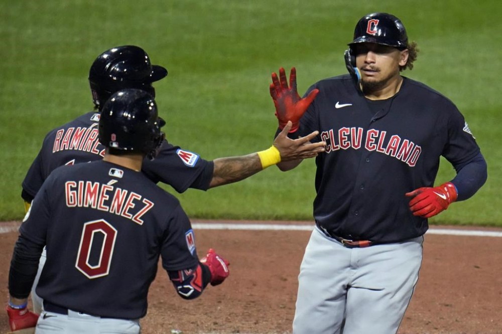Cleveland Guardians' Josh Naylor, right, heads back to the dugout after hitting a two-run home run off Pittsburgh Pirates relief pitcher Yohan Ramirez during the ninth inning of a baseball game in Pittsburgh, Tuesday, July 18, 2023. (AP Photo/Gene J. Puskar)