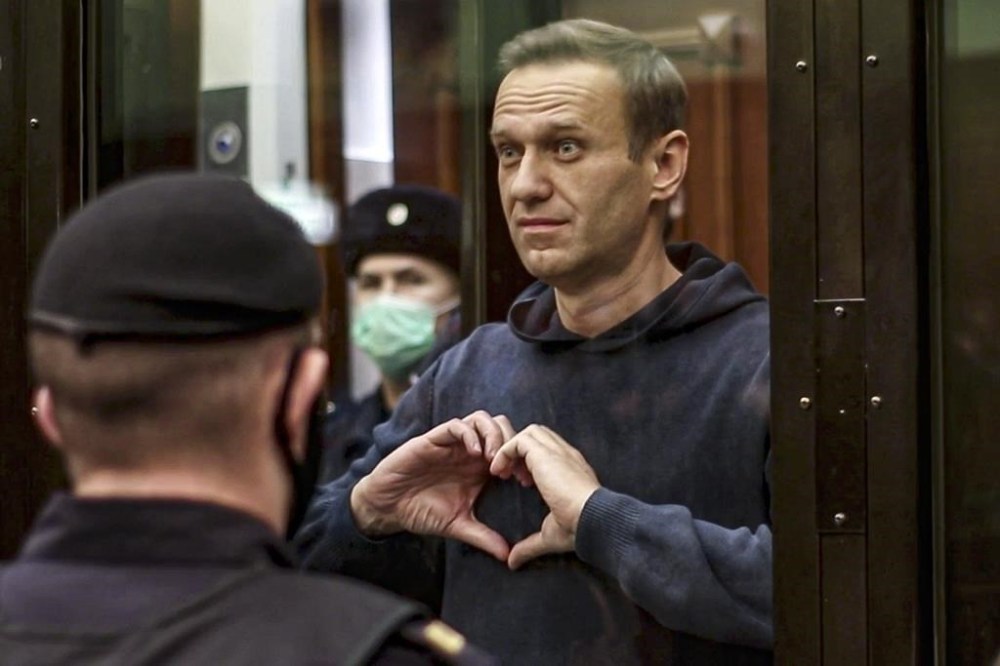 FILE - In this file photo made from video provided by the Moscow City Court on Wednesday, Feb. 3, 2021, Russian opposition leader Alexei Navalny makes a heart gesture standing in a cage during a hearing in Moscow, Russia. The prosecution has asked the court to sentence imprisoned opposition leader Alexei Navalny to 20 years in prison on extremism charges, his ally Ivan Zhdanov said Thursday July 20, 2023. According to Zhdanov, the trial against Navalny, which went on behind closed doors in the prison where the politician is serving another lengthy sentence, is scheduled to conclude with a verdict on Aug. 4. (Moscow City Court via AP, File)