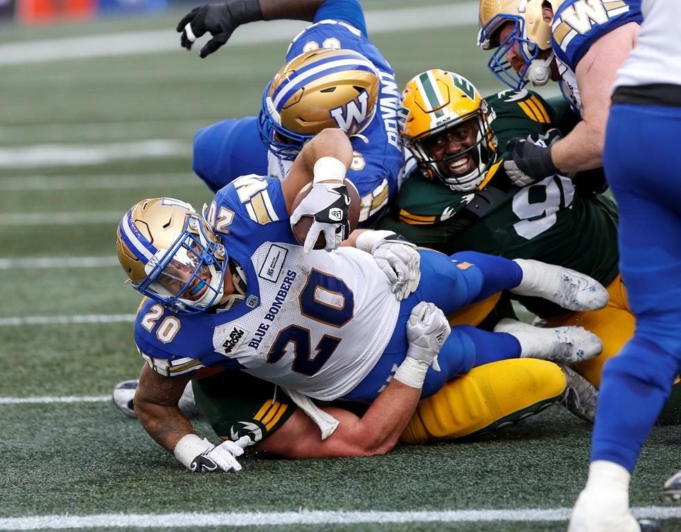 Winnipeg Blue Bombers Brady Oliveira (20) reaches out for the end zone but is short of the touchdown against the Edmonton Elks during first half CFL action in Winnipeg Thursday, July 20, 2023.THE CANADIAN PRESS/John Woods