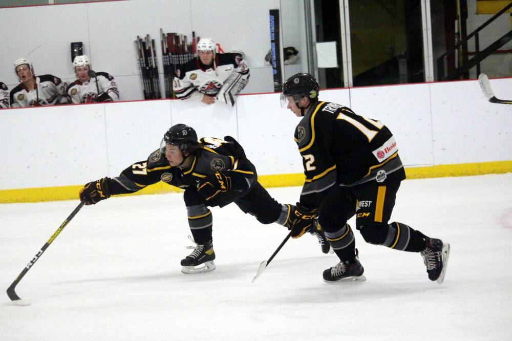 Cameron Trimble (12) and Neepawa Titans teammates Brayden Michalchuk move their way up the ice.