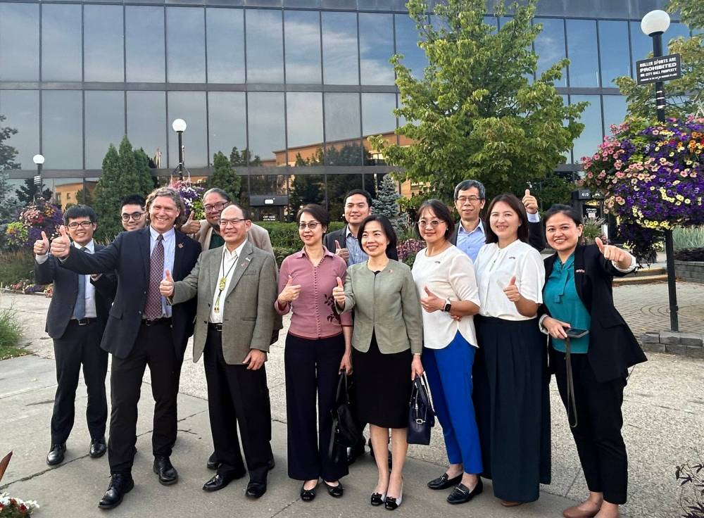 Dakota Ojibway Tribal Council director of operations Maeengan Linklater, Brandon Mayor Jeff Fawcett and members of a Taiwanese trade delegation, including Ambassador Harry Tseng, stand outside Brandon City Hall on Wednesday. The delegation visited several locations in Manitoba as part of a tour set up by DOTC. (City of Brandon)