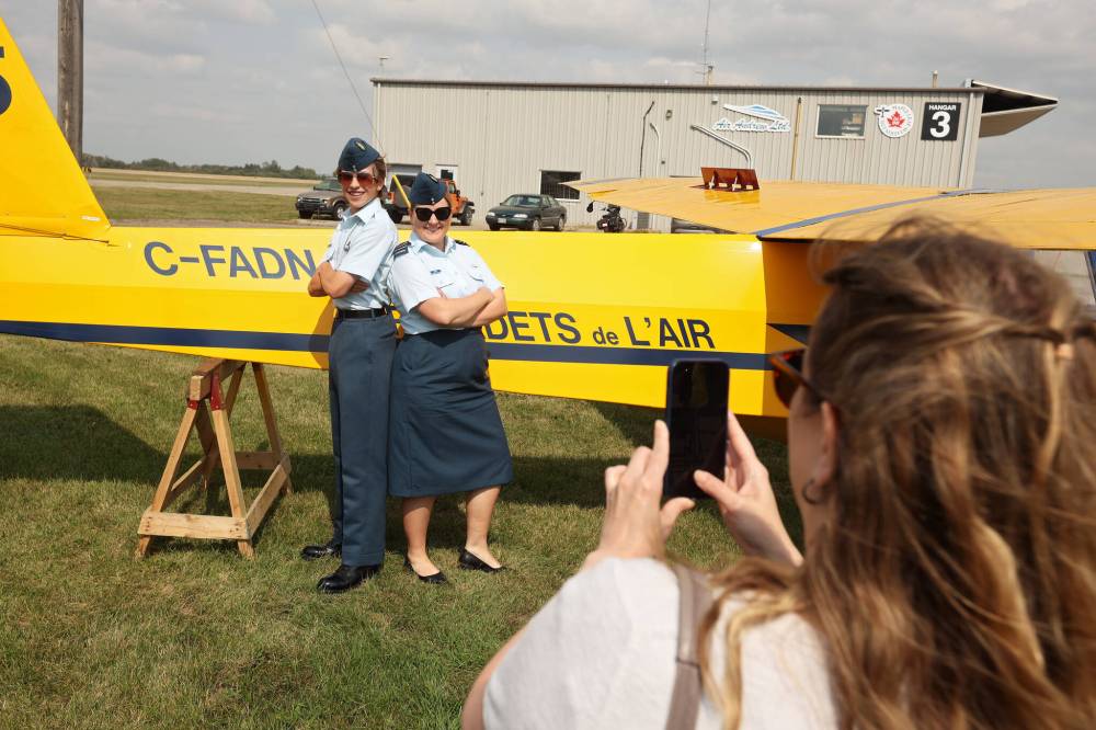 Course Cadet Declan Funnell of 699 Jasper Place Royal Canadian Air Cadet Squadron in Edmonton poses for photos in front of a glider with Capt. Morgan Herda, glider instructor and deputy flight commander of Apollo Flight, after Funnell received his glider pilot licence during the Brandon Cadet Training Centre graduation ceremony at the Commonwealth Air Training Plan Museum on Friday.
LEFT: Course Cadet Declan Funnell of 699 Jasper Place Royal Canadian Air Cadet Squadron in Edmonton poses for photos in front of a glider with Capt. Morgan Herda, glider instructor and deputy flight commander of Apollo Flight, after Funnell received his glider pilot licence during the Brandon Cadet Training Centre graduation ceremony at the Commonwealth Air Training Plan Museum on Friday. RIGHT: Course Cadets march on parade after receiving their glider pilot training course wings at Friday’s graduation ceremony. (Photos by Tim Smith/The Brandon Sun)