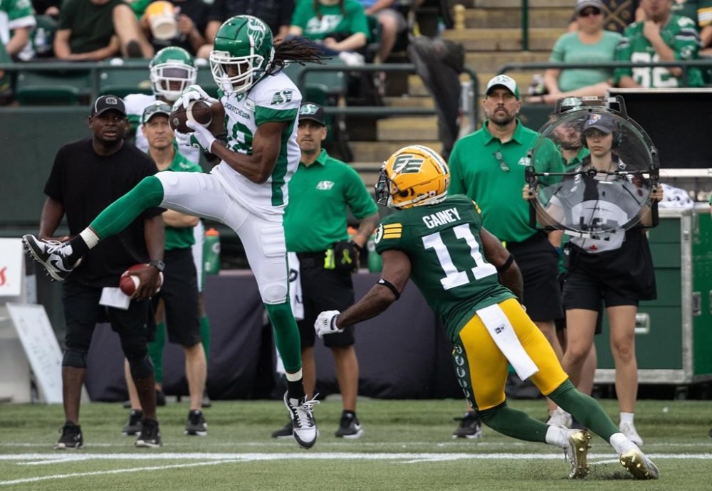 Saskatchewan Roughriders Derel Walker (18) makes the catch as Edmonton Elks Ed Gainey (11) tries to stop him during first half CFL action in Edmonton, Alta., on Sunday June 11, 2023. The Roughriders released Walker on Wednesday. THE CANADIAN PRESS/Jason Franson.