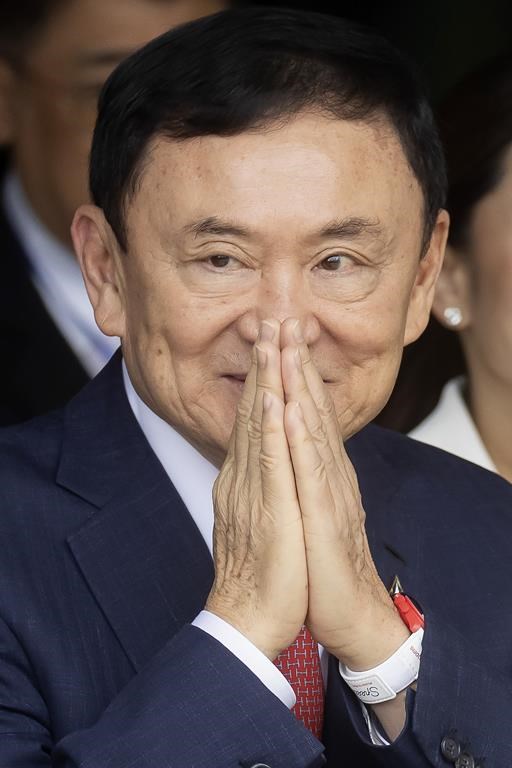 Thailand's former Prime Minister Thaksin Shinawatra greets his supporters as he arrives at Don Muang airport in Bangkok, Thailand, Tuesday, Aug. 22, 2023. (AP Photo/Wason Wanichakorn)