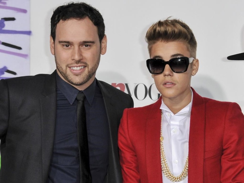 FILE - Music executive Scooter Braun, left, appears with Justin Bieber at the World Premiere of