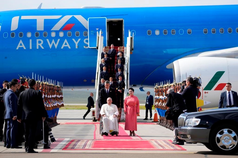 Pope Francis is received by the Foreign Minister of Mongolia, Batmunkh Battsetseg, right, as he arrives at Ulaanbaatar's International airport Chinggis Khaan, Friday, Sept. 1, 2023. Pope Francis is traveling to Mongolia to encourage one of the world's smallest and newest Catholic communities. It's the first time a pope has visited the Asian country and comes at a time when the Vatican's relations with Mongolia's two powerful neighbors, Russia and China, are once again strained. (AP Photo/Andrew Medichini)