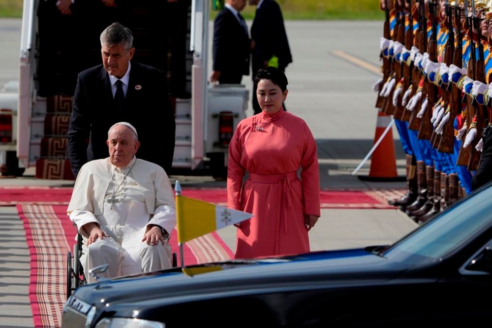 Pope Francis is received by the Foreign Minister of Mongolia, Batmunkh Battsetseg, rightas he arrives at Ulaanbaatar's International airport Chinggis Khaan, Friday, Sept. 1, 2023. Pope Francis is traveling to Mongolia to encourage one of the world's smallest and newest Catholic communities. It's the first time a pope has visited the Asian country and comes at a time when the Vatican's relations with Mongolia's two powerful neighbors, Russia and China, are once again strained. (AP Photo/Ng Han Guan)