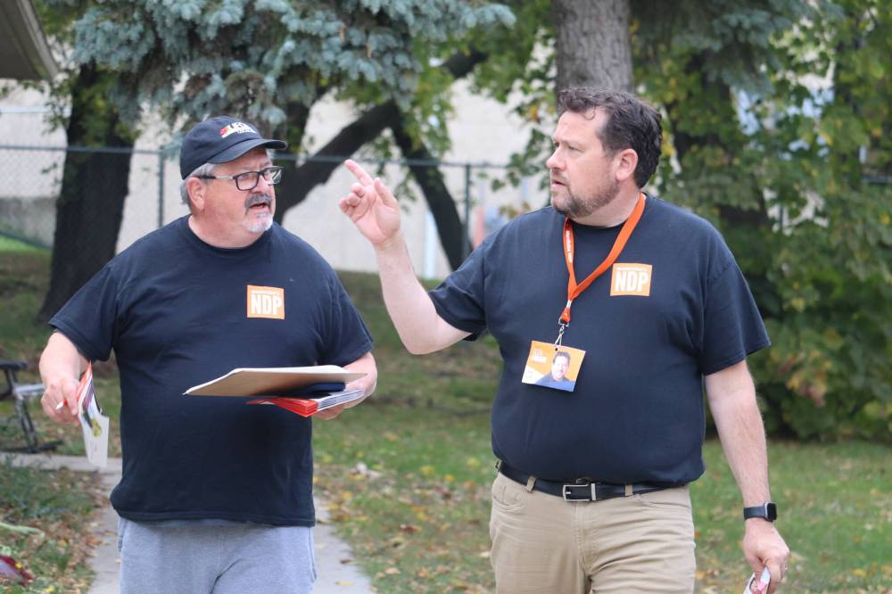 Brandon East NDP candidate Glen Simard canvasses a neighbourhood near Kin Park late Friday afternoon alongside campaign volunteer Ray Berthelette. (Kyle Darbyson/The Brandon Sun)
