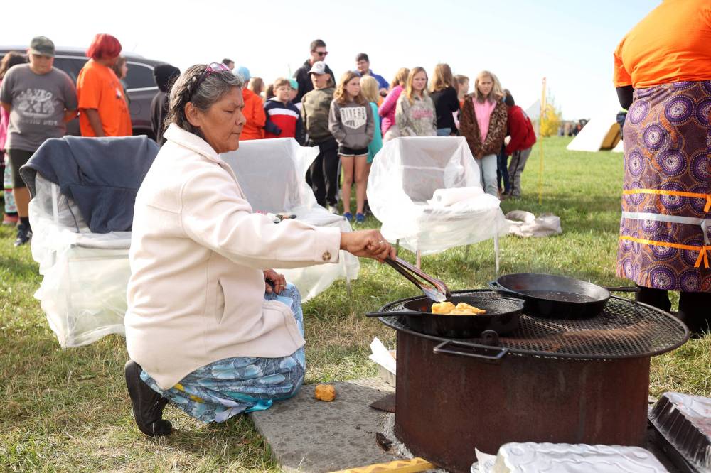 Shirley Brightnose, an administrative assistant with Jordan's Principle, cooks bannock for students on a third day of educational programming for Westman students during Truth and Reconciliation Week at the Riverbank Discovery Centre. The federal government is failing First Nations children, and putting their well-being in jeopardy. It needs to provide the leadership, commitment and resources required to fix this problem as quickly as possible, and ensure it never happens again, Brandon Sun columnist Deveryn Ross writes. (File)