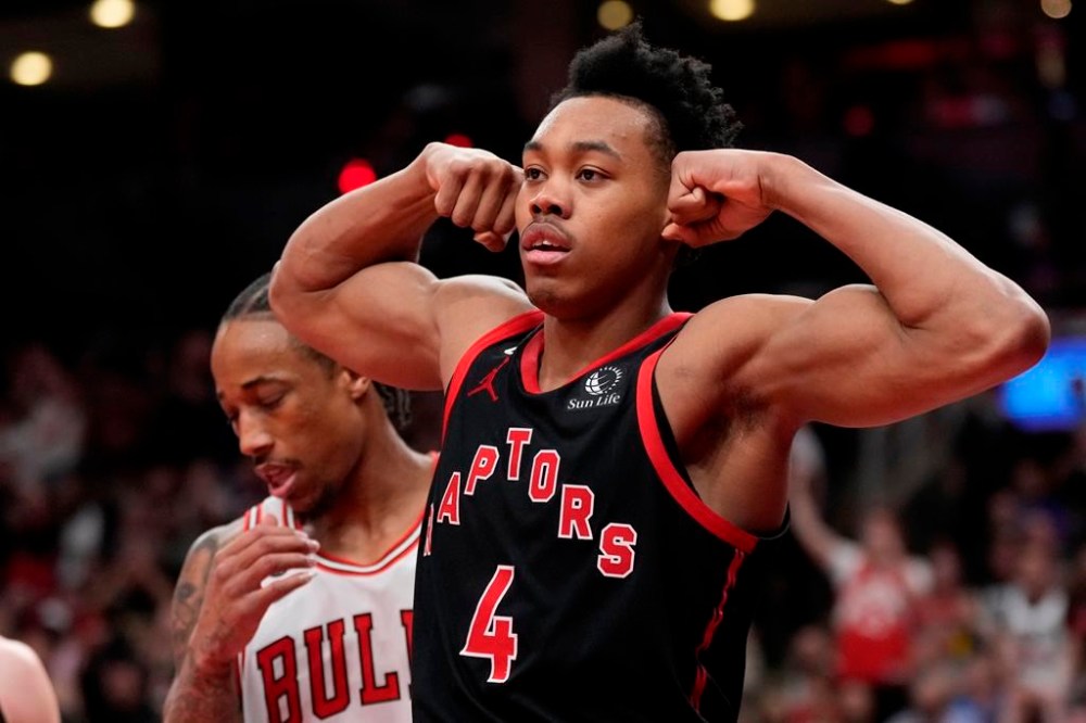 Toronto Raptors forward Scottie Barnes (4) strikes a pose as Chicago Bulls forward DeMar DeRozan (11) looks on during second half NBA basketball action in Toronto on Wednesday, April 12, 2023. THE CANADIAN PRESS/Frank Gunn