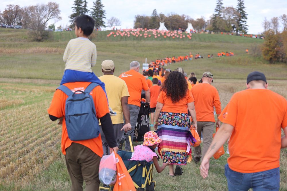 Brandon’s Orange Shirt Day participants climb a hill towards the site of the old Brandon Indian Residential School. The orange hearts that decorate the hill symbolize the children who attended the school between 1895 and 1972 and never returned home. (Kyle Darbyson/The Brandon Sun)