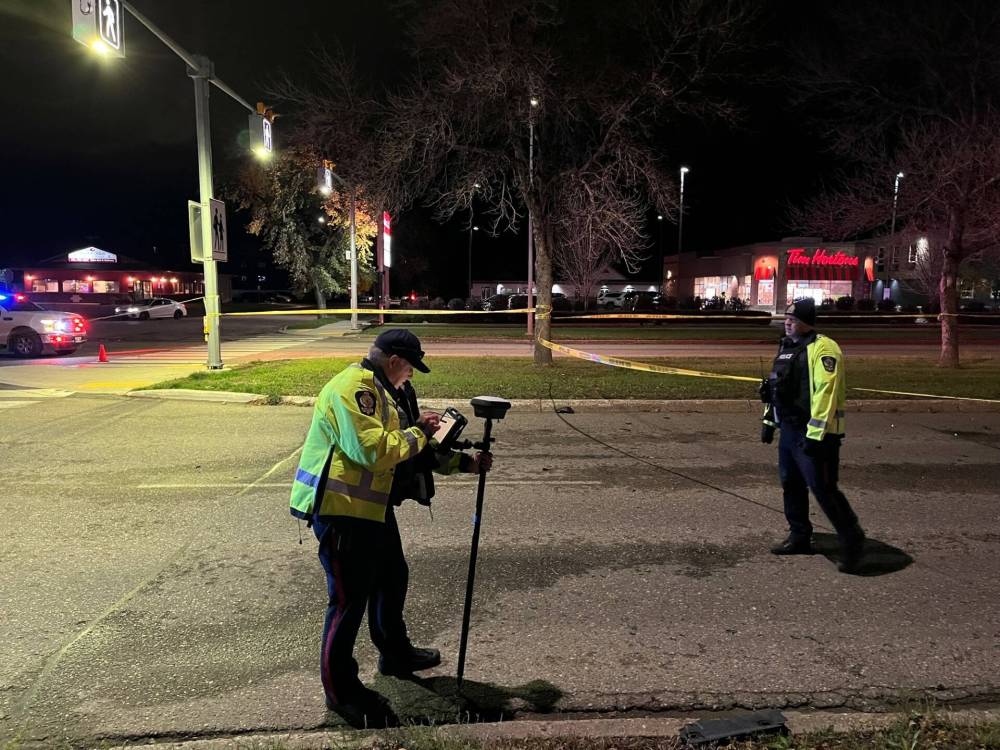 Brandon Police Service investigators on the scene of a cyclist fatality in the intersection of Victoria Avenue and McDiarmid Drive on Thursday evening. (Photos by Matt Goerzen/The Brandon Sun)