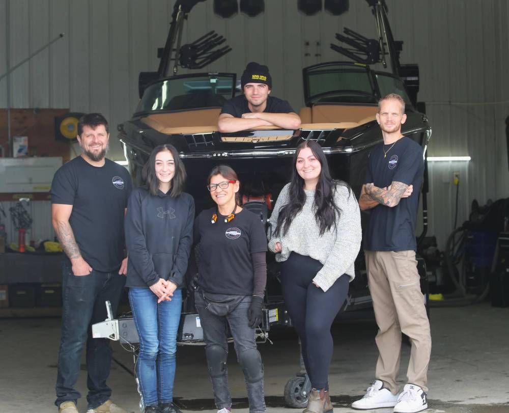 Darren Darvill (far right), the owner and operator of Resurrection Auto Detailing Tint and Protection, poses for a photo with his staff in Brandon on Thursday. From left, Matt Ross, Lainey Fidler, Shawn Simpson, Jordan Bedford, with Zach Heidie in the boat. (Photos by Michele McDougall/The Brandon Sun)