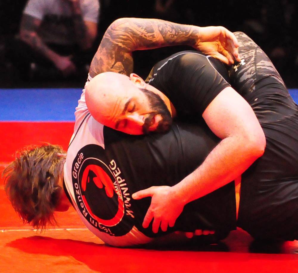 2PPCLI Cpl. Kevin Camara, a brown belt, rolls with black belt Alan Devries of DST last April at Wamma Brandon's inaugural Brandon Bouts jiu-jitsu at the Western Manitoba Centennial Auditorium. (Jules Xavier/For The Sun)