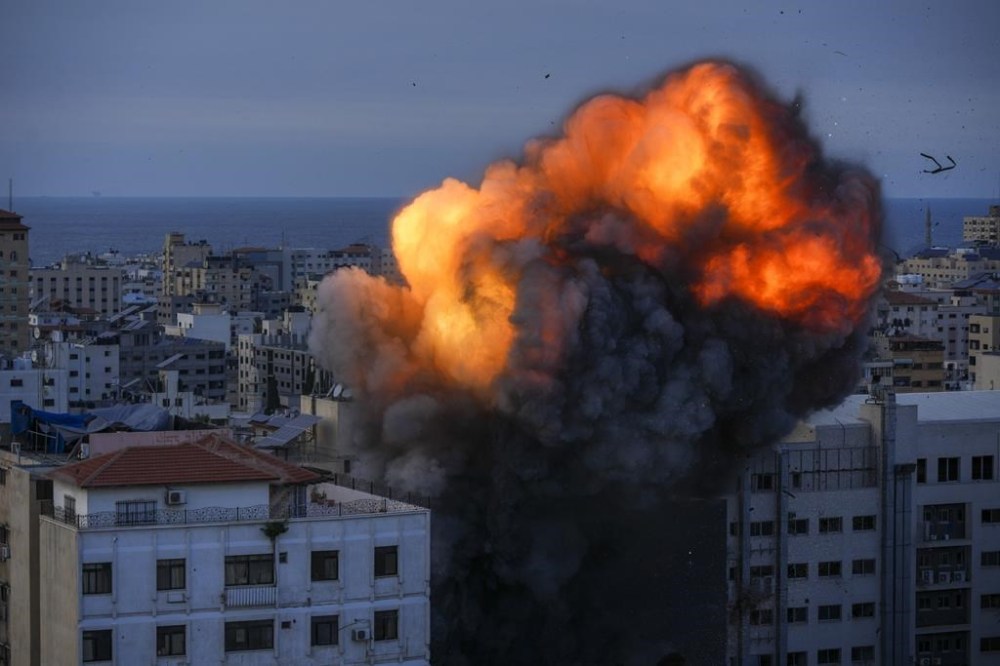 Fire and smoke rise following an Israeli airstrike, in Gaza City, Sunday, Oct. 8, 2023. A group from a B.C. church was on a tour in Israel to explore the historical sites when the Israel-Hamas war broke out on Saturday, leaving the group struggling to find a way home.THE CANADIAN PRESS/AP/Hatem Moussa