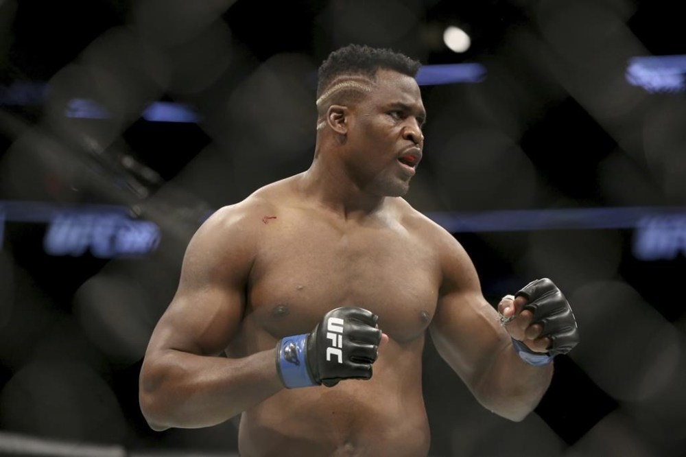 FILE - Francis Ngannou during a heavyweight championship mixed martial arts bout against Stipe Miocic at UFC 220, Sunday, Jan. 21, 2018, in Boston. Being the best heavyweight boxer in the world isn’t enough for Tyson Fury. He has appeared in WWE, been the subject of a Netflix reality series and is now in the Middle East to fight a former UFC star in the latest in a crossover bouts. Fighting Francis Ngannou on Saturday, Oct. 28, 2023 will earn Fury a reported $50 million. (AP Photo/Gregory Payan, File)