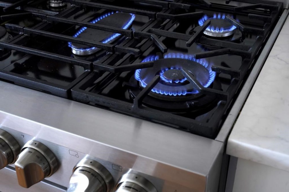 Flames emerge from burners on a natural gas stove, Wednesday, June 21, 2023, in Walpole, Mass. Montreal will ban gas-powered systems in new construction starting next fall, with some notable exceptions. THE CANADIAN PRESS/AP-Steven Senne