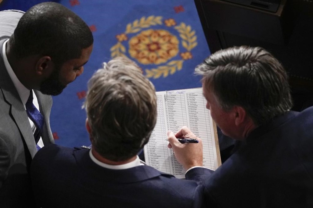 Members look at a voting tally sheet as Republicans try to elect Rep. Mike Johnson, R-La., to be the new House speaker, at the Capitol in Washington, Wednesday, Oct. 25, 2023. (AP Photo/Alex Brandon)