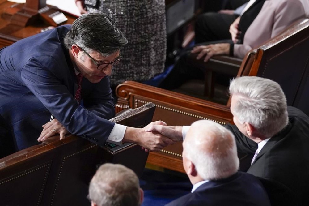 Rep. Mike Johnson, R-La., shakes hands with Rep. Kevin McCarthy, R-Calif., before Republicans try to elect Johnson to be the new House speaker, at the Capitol in Washington, Wednesday, Oct. 25, 2023. (AP Photo/Alex Brandon)