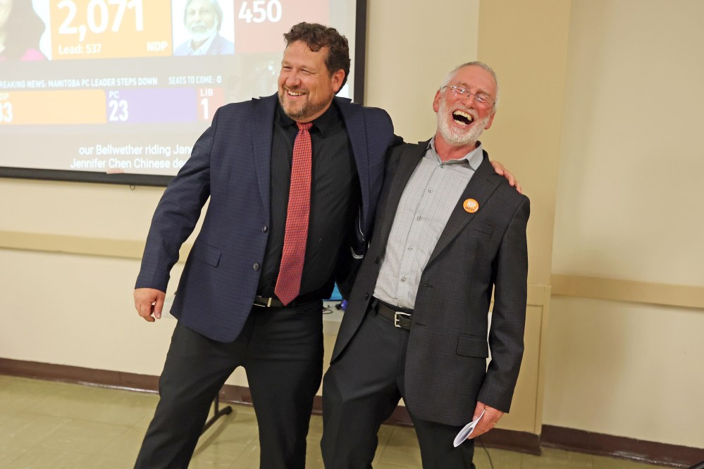Brandon East NDP candidate Glen Simard and Brandon West NDP candidate Quentin Robinson share a laugh while giving speeches at the Brandon NDP campaign party at the Royal Canadian Legion Branch 3 on Victoria Avenue East on Tuesday evening. As of 11:00PM Simard won the Brandon East Riding and results were still too close to call in Brandon West.
(Tim Smith/The Brandon Sun)