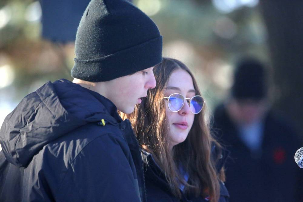 Riverheights School Grade 8 students Valentyne Gasuliak, left, and Aubreigh Atchison read the