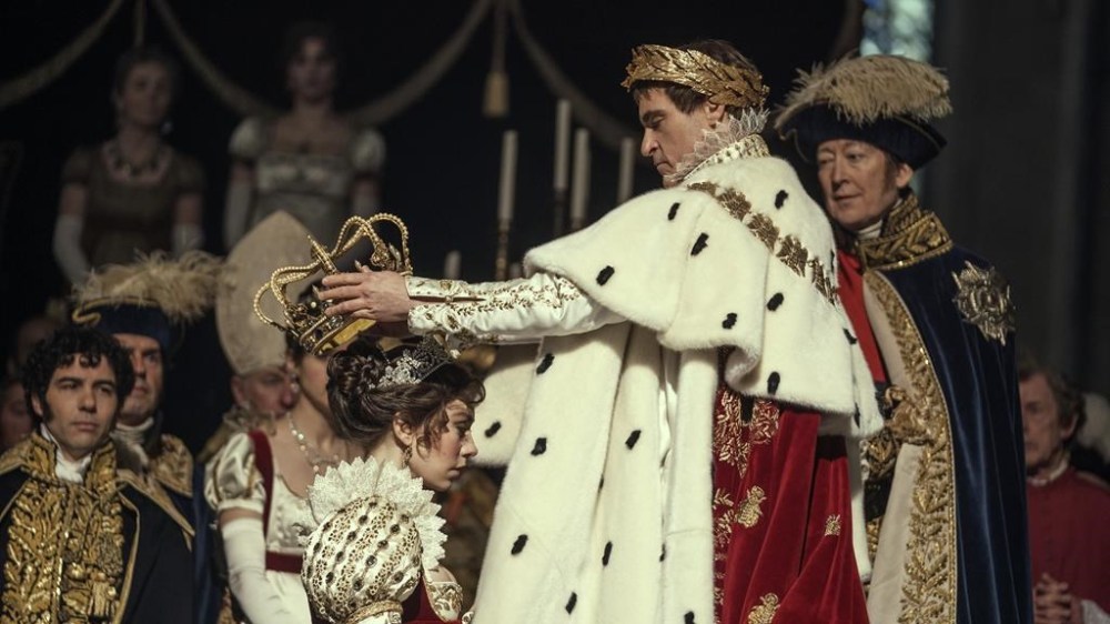 This image released by Apple TV+ shows Vanessa Kirby, foreground left, and Joaquin Phoenix in a scene from