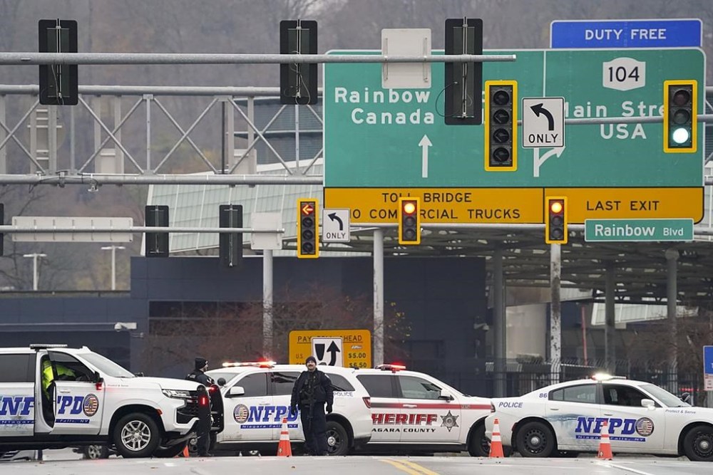 Law enforcement personnel block off the entrance to the Rainbow Bridge, Wednesday, Nov. 22, 2023, in Niagara Falls, N.Y. The border crossing between the U.S. and Canada has been closed after a vehicle exploded at a checkpoint on a bridge near Niagara Falls. The FBI's field office in Buffalo said in a statement that it was investigating the explosion on the Rainbow Bridge, which connects the two countries across the Niagara River.THE CANADIAN PRESS/Derek Gee/The Buffalo News via AP