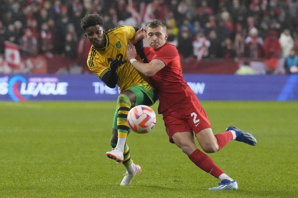 Jamaica's Demarai Grav (left) battles for the ball with Canada's Alistair Johnston during second half CONCACAF Nations League quarterfinal action in Toronto, on Tuesday, November 21, 2023. Canada has dropped three places to No. 48 in the latest FIFA world rankings in the wake of its CONCACAF Nations League quarterfinal loss to Jamaica. THE CANADIAN PRESS/Chris Young