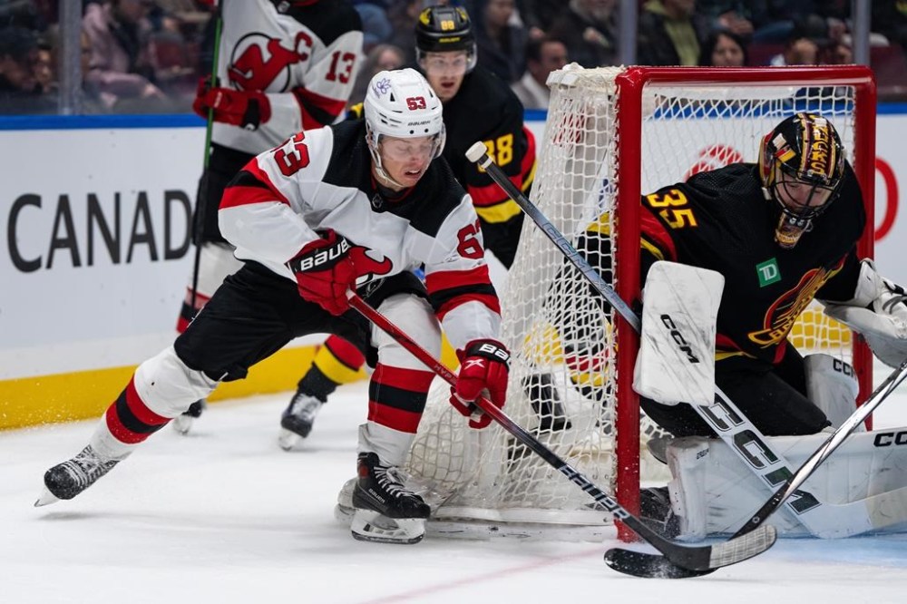 Vancouver Canucks goaltender Thatcher Demko (35) stops New Jersey Devils' Jesper Bratt (63) during the second period of an NHL hockey game in Vancouver on Tuesday, Dec. 5, 2023. THE CANADIAN PRESS/Ethan Cairns