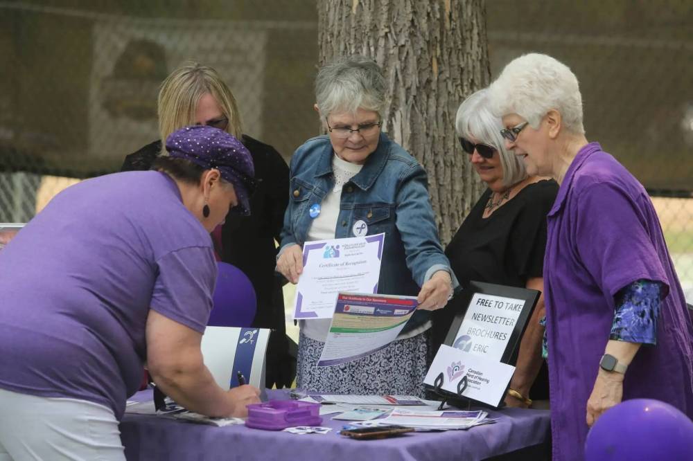 Meryl Orth, far right, committee co-chair of Brandon's Health Checks, is with other local volunteers at the June 2023 Elder Abuse Awareness Day in Brandon's Stanley Park. (File)