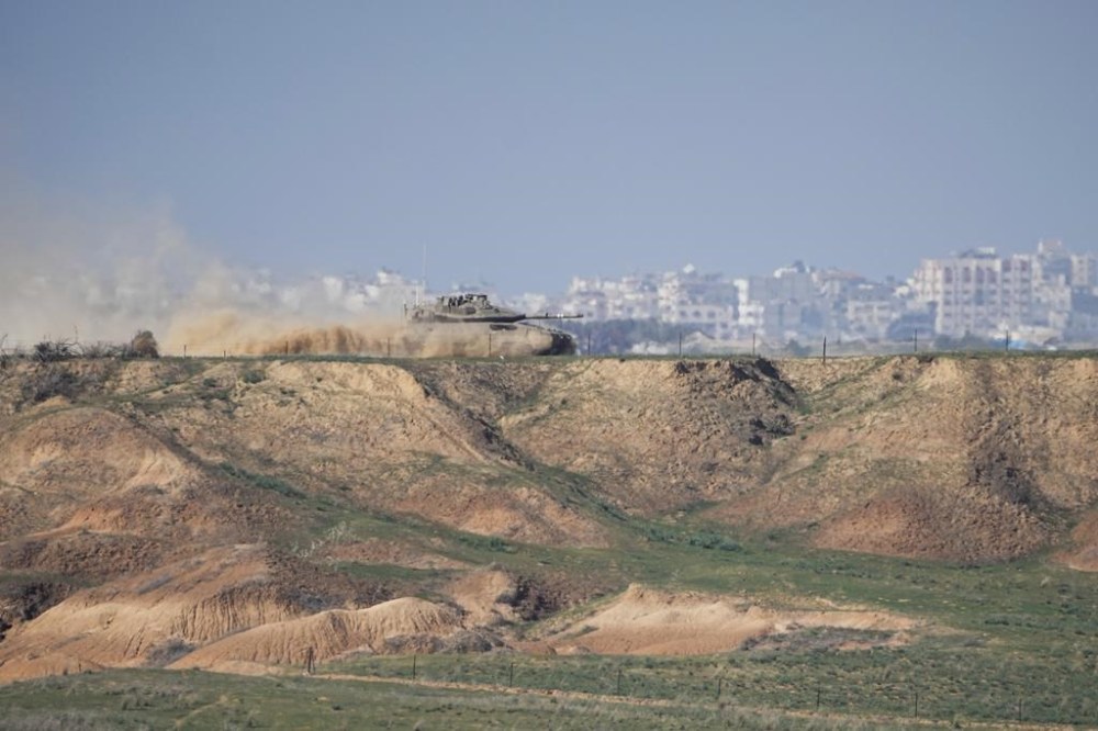 An Israeli army tank moves along the border with Gaza Strip, in southern Israel, Sunday, Dec. 24, 2023. The army is battling Palestinian militants across Gaza in the war ignited by Hamas' Oct. 7 attack into Israel. (AP Photo/Ariel Schalit)